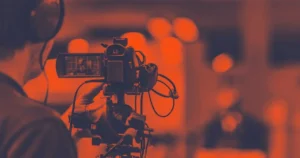 Why You Need to Include Hybrid Events in Your 2022 Strategy Broadcast camera filming a hybrid event