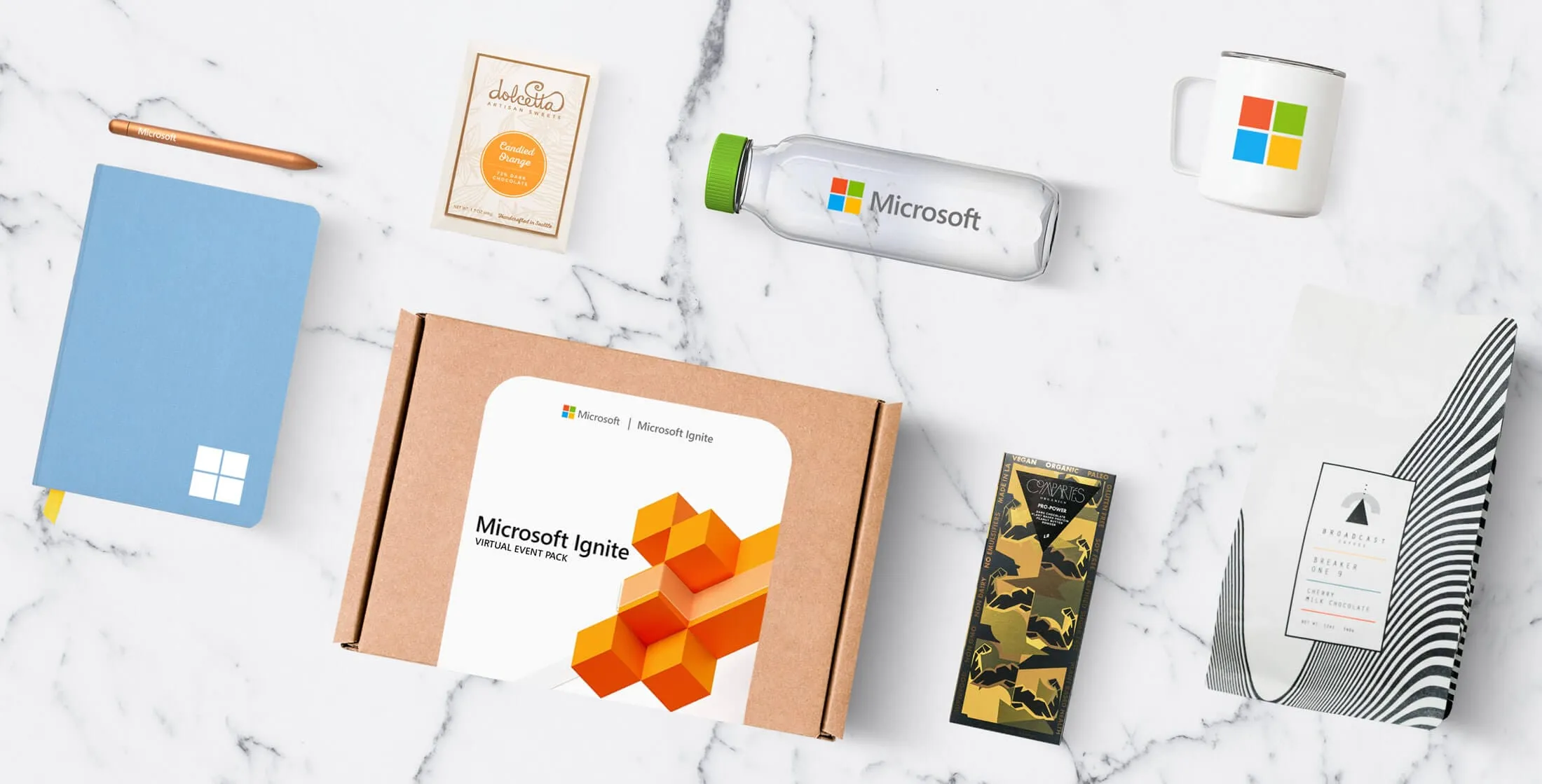 Flat lay of branded Microsoft Ignite event swag in a gift box
