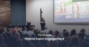 Hybrid Event Engagement: Strategies That Work A group of people in front of a screen engaging in a hybrid event.