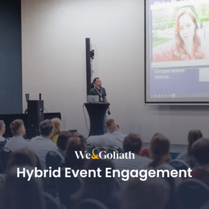 Hybrid Event Engagement: Strategies That Work A group of people in front of a screen engaging in a hybrid event.