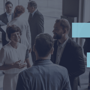 Hybrid Meetings: What They Are and How to Make Them Work A virtual event checklist being discussed by a group of people in a meeting room.