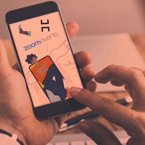 19 Must-Have Mobile Event Apps to Try in 2024 A man holding a smartphone with an image of a cartoon character on it.