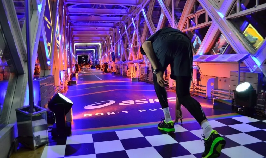 Skateboarder riding through a neon-lit brand activation
