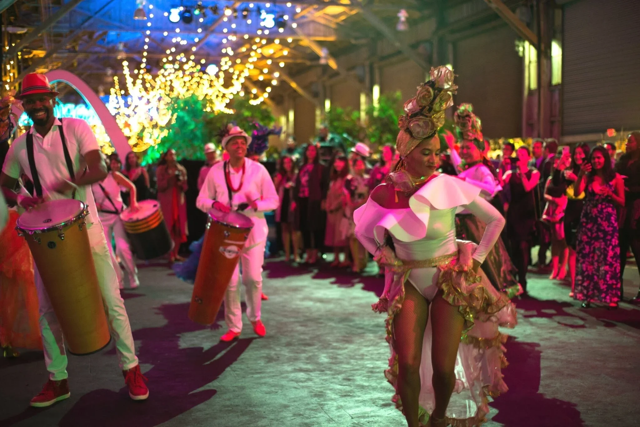 Costumed drummers performing at a colourful corporate party