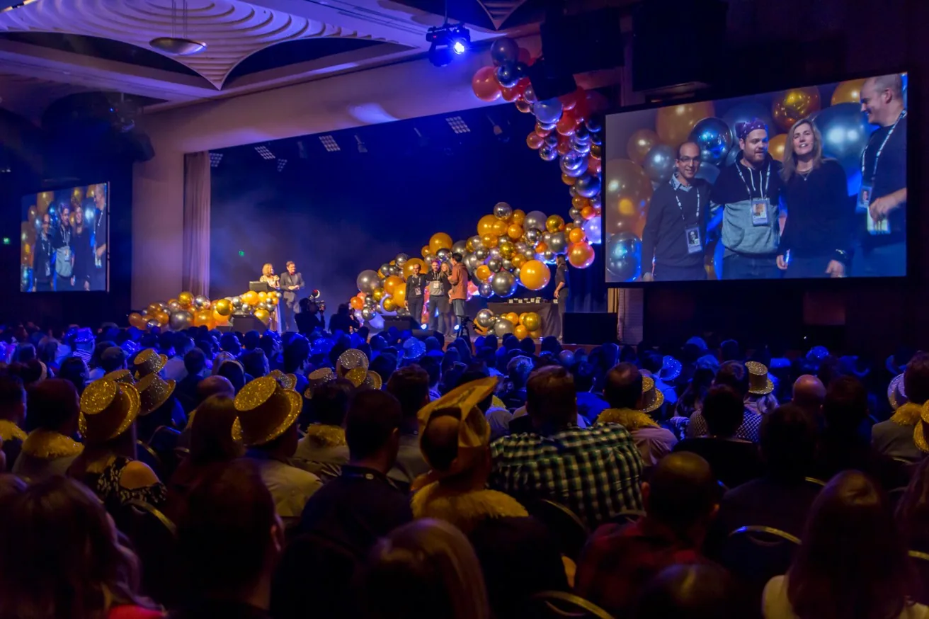 Audience watching a lit stage show at a gala