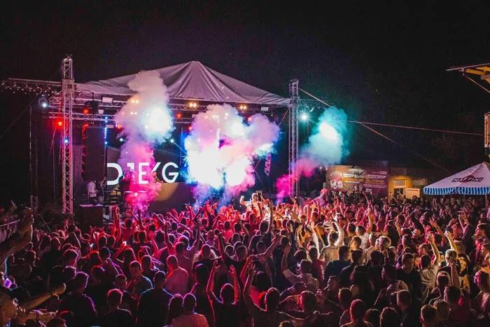 Festival crowd in front of a lit outdoor stage