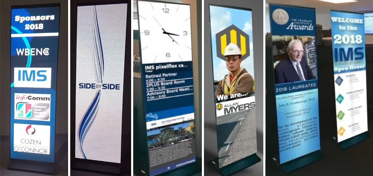 Row of digital signage screens at a conference