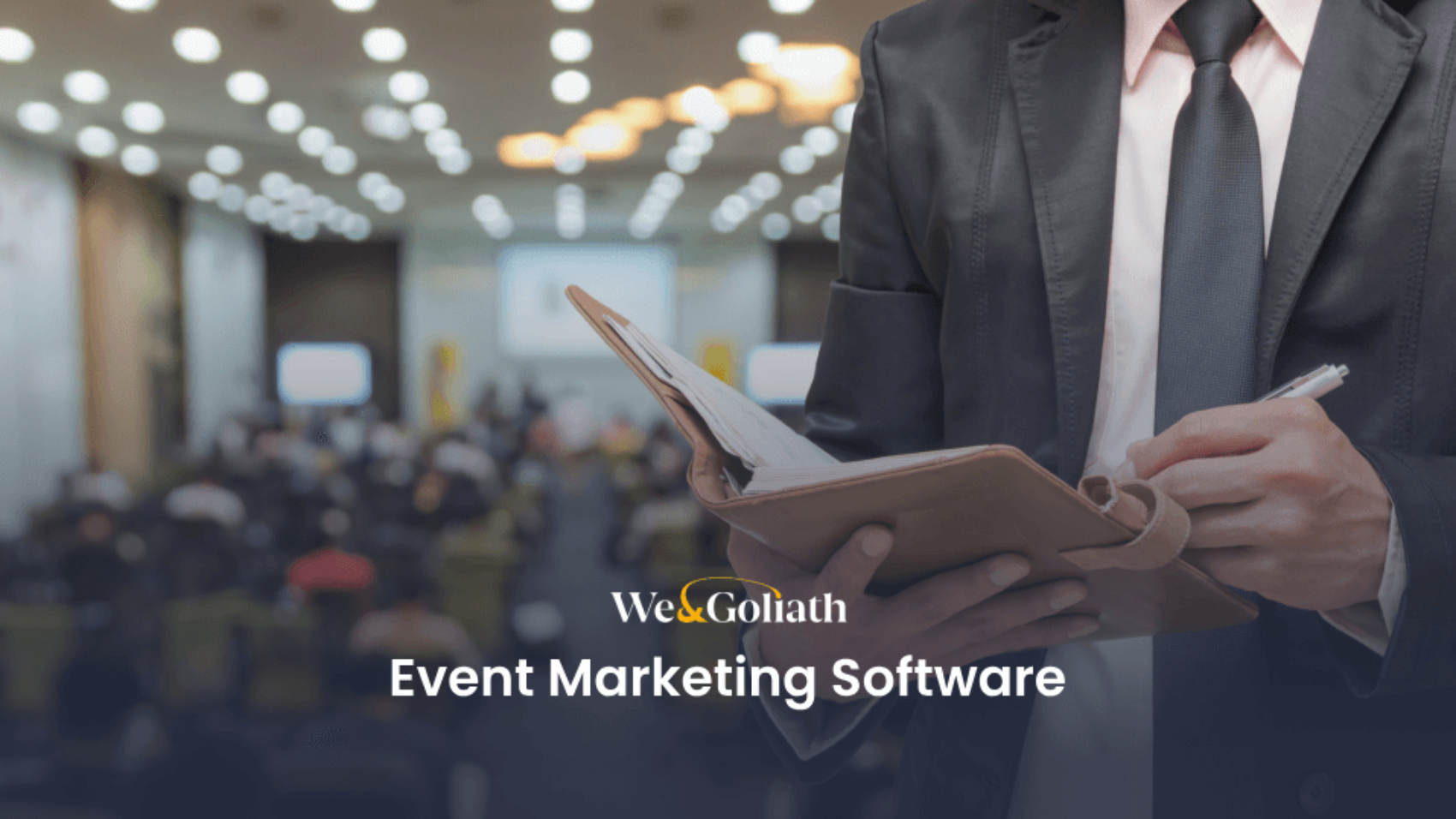 A man in a suit is holding a notebook with the words event marketing software.
