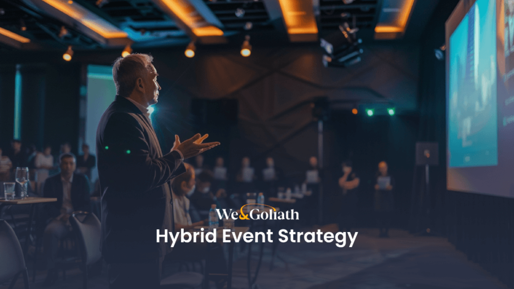 Speaker presenting at a hybrid event conference.