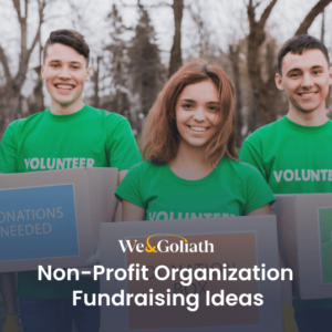 Group of smiling volunteers holding signs for donations and fundraising.