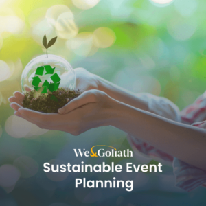 Person holding a plant with a recycling symbol, promoting sustainable event planning.