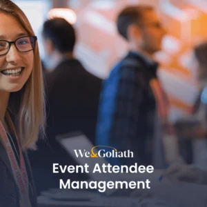 Event Attendee Management: An Attendee-Centric Approach Two women smiling at a registration desk during an event with a logo and text that reads "webgoliath event attendee management".