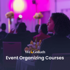 Attendees at an event with a focus on event organizing courses, with a woman facing the camera in the foreground.
