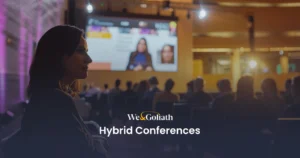 Hybrid Conference Best Practices for Success Woman attending a hybrid conference with both in-person and virtual elements, presented by we&goliath.
