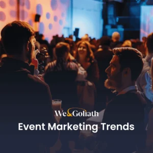6 Event Marketing Trends to Elevate Your Events in 2025 A networking event with people gathered in a dimly lit room, highlighting a presentation slide titled "Event Marketing Trends.