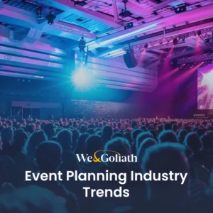 The Biggest Event Planning Industry Trends of 2024 A large crowd at an indoor conference event with vibrant stage lighting and "event planning industry trends" text overlay.