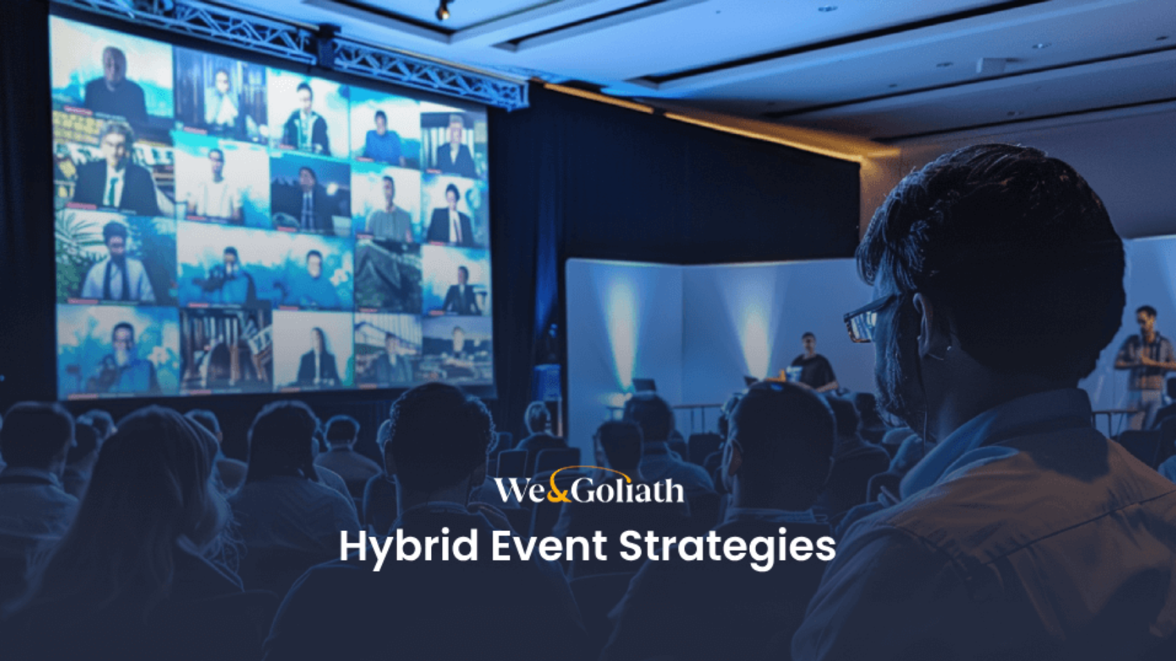 Audience at a hybrid event viewing multiple virtual speakers displayed on a large screen, with the text "webgoliath hybrid event strategies" overlaying the image.