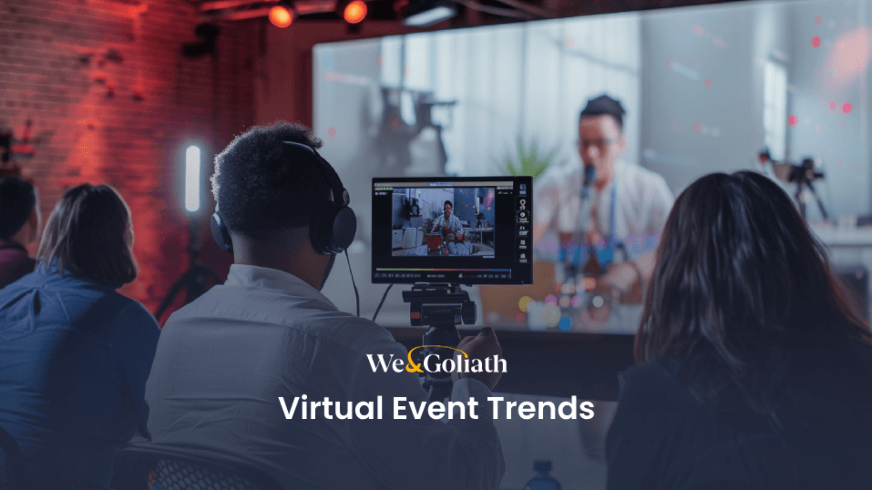 People wearing headphones attending a virtual event shown on a screen, with text overlay "we&goliath virtual event trends".