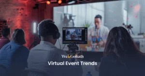 6 Cutting-Edge Virtual Event Trends Shaping the Industry in 2025 People wearing headphones attending a virtual event shown on a screen, with text overlay "we&goliath virtual event trends".