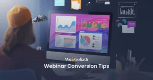 Mastering the Art and Science of High-Converting Webinars A person wearing a hat looks at a computer screen displaying graphs and charts. The text "Webinar Conversion Tips" and "We&Goliath" are visible on the screen, highlighting essential strategies for boosting webinar conversion rates.