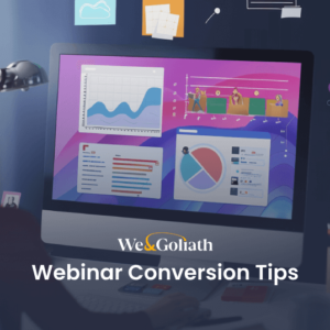 Mastering the Art and Science of High-Converting Webinars A person wearing a hat looks at a computer screen displaying graphs and charts. The text "Webinar Conversion Tips" and "We&Goliath" are visible on the screen, highlighting essential strategies for boosting webinar conversion rates.