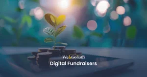 Digital Fundraising Hacks: Amplify Your Nonprofit's Reach A small plant grows from a stack of coins on a tablet screen. The text "We & Goliath Digital Fundraisers" is displayed in front of the image.