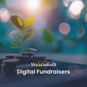 A small plant grows from a stack of coins on a tablet screen. The text "We & Goliath Digital Fundraisers" is displayed in front of the image.