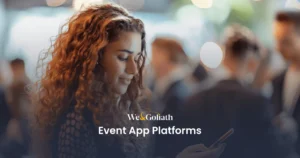 Mobile Event Apps Transforming Conference Management A woman with curly hair is using a smartphone at an event. The text "We & Goliath Event App Platforms" is prominently displayed. Several other blurred people are in the background.
