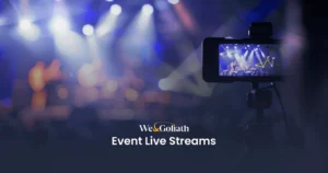 How to Live Stream Your Event: Pro Tips & Tools A camera records a live event with people on stage, with "We and Goliath Event Live Streams" text overlay in the foreground.