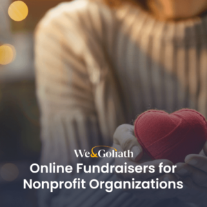 Person holding a small, red heart-shaped object next to text that reads, "We & Goliath: Online Fundraisers for Nonprofit Organizations.