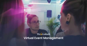 Mastering Virtual Event Planning and Management People engaged in conversation at an event, with a "We&Goliath Virtual Event Management" sign.