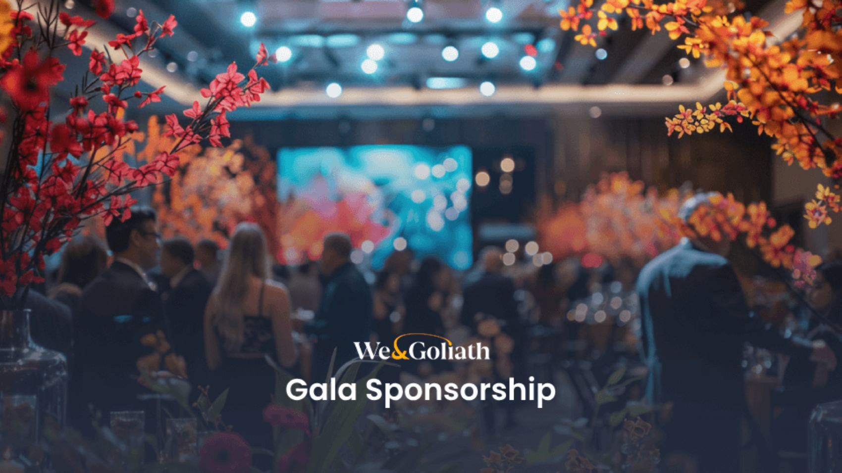 A gala event with attendees seated and mingling, illuminated by vibrant lighting and floral decor. The text "We & Goliath Gala Sponsorship" is overlayed at the bottom of the image.