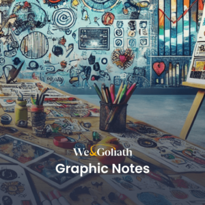 What Are Graphic Notes? An Introduction to Visual Note-Taking Techniques A cluttered studio with tables and walls covered in colorful graphic notes, drawings, and sketches. Art supplies and tools are scattered across the work surface. Text on image: "We & Goliath Graphic Notes.