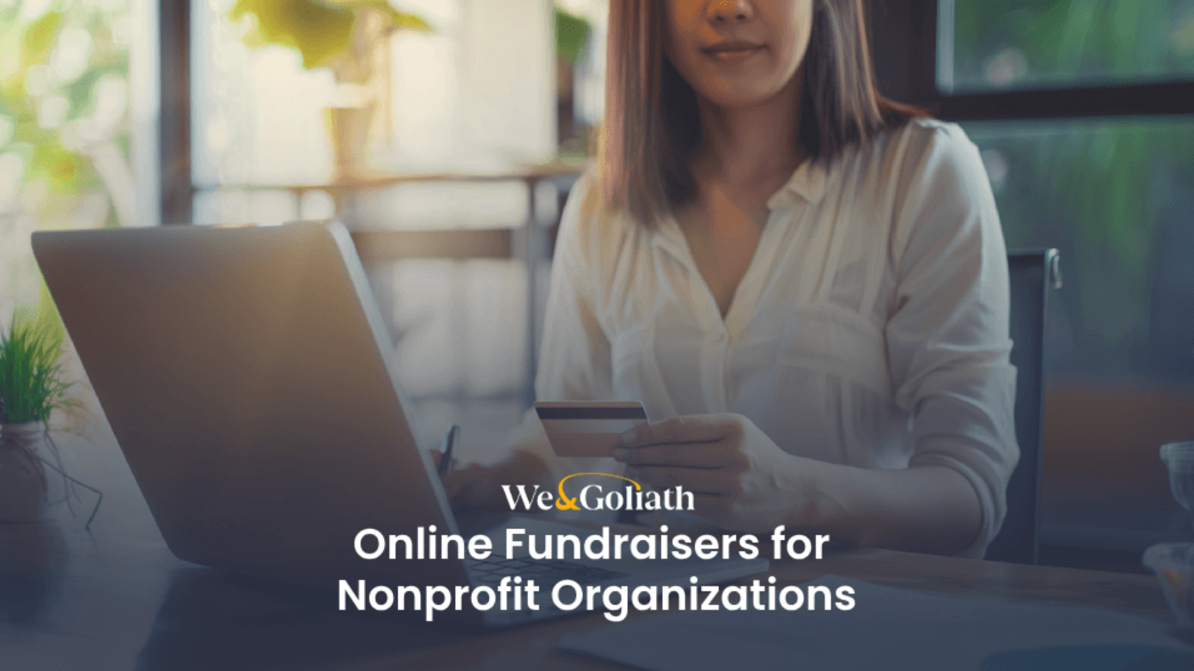A person holding a credit card sits at a desk with a laptop. Overlay text reads, "We & Goliath Online Fundraisers for Nonprofit Organizations.