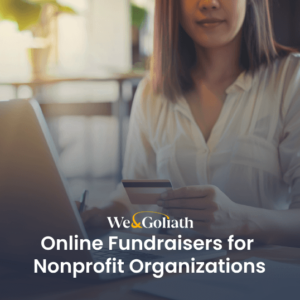 Online Fundraising: Ideas for Nonprofits A person holding a credit card sits at a desk with a laptop. Overlay text reads, "We & Goliath Online Fundraisers for Nonprofit Organizations.