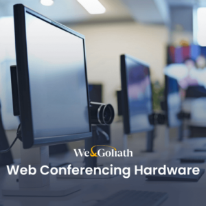 A row of computer monitors equipped with webcams is shown in an office setting. The text reads "We&Goliath Web Conferencing Hardware.
