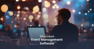 The Ultimate Guide to Event Management Solutions We and Goliath cover for event management software, showing a guest using a laptop at an event