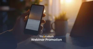 Mastering the Art of Marketing Online Seminars We and Goliath cover for webinar promotion, showing a hand holding a phone at a desk