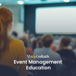 A person attends a presentation in a dimly lit auditorium, with a screen in front and an audience seated. Text reads "We & Goliath Event Management Education," providing insight into the intricacies of coordinating successful events.
