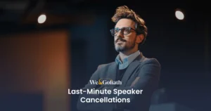 Strategies for Handling Speaker Cancellations We and Goliath cover for last-minute speaker cancellations, showing a speaker in a dark room