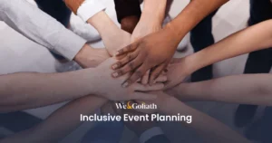 Best Practices for Creating Welcoming Events We and Goliath cover for inclusive event planning, showing hands stacked in a team huddle