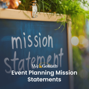A chalkboard displaying the event planning mission statement is surrounded by lush greenery. Text overlay reads: "We & Goliath Event Planning Mission Statements.