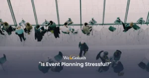 Why is Event Planning So Stressful? We and Goliath cover asking whether event planning is stressful, showing chairs suspended in a room