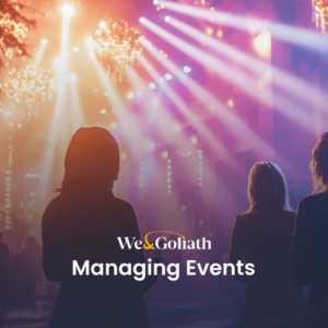 Exploring the World of Event Management Silhouettes of three people face vibrant stage lights at an event, with "We & Goliath Seamlessly Managing Events" text overlay.