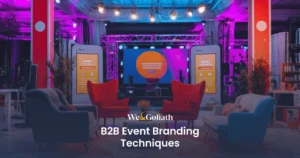 Useful Branding Strategies for Successful B2B Events We and Goliath cover for B2B event branding techniques, showing a branded stage lounge