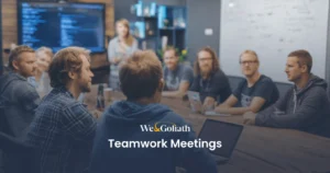 Creating Engaging Agendas for Effective Team Meetings We and Goliath cover for teamwork meetings, showing a team around a boardroom screen